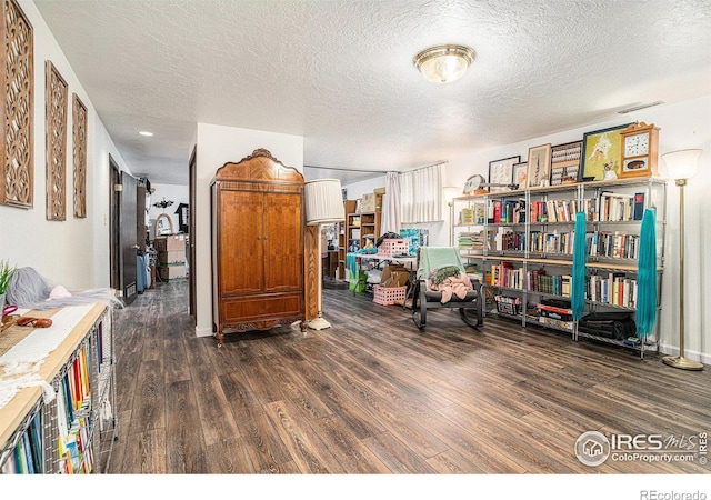 interior space featuring wood finished floors and a textured ceiling