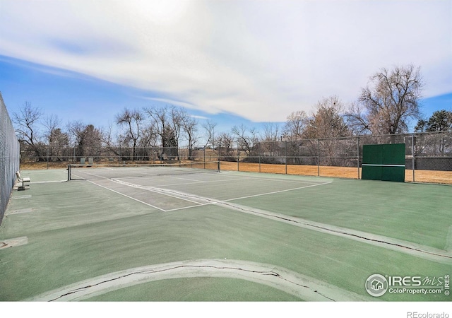 view of tennis court with fence