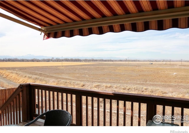 wooden terrace with a rural view