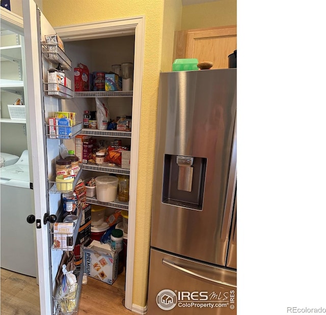 storage area featuring independent washer and dryer