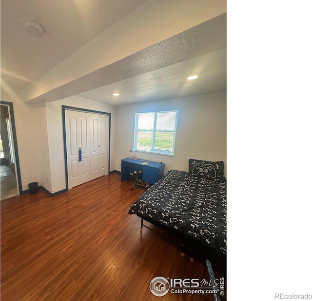 bedroom featuring recessed lighting, wood finished floors, a closet, and baseboards