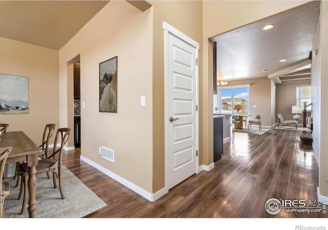 interior space with visible vents, dark wood-type flooring, and baseboards