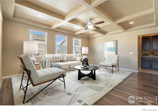 living room featuring visible vents, light wood-style flooring, coffered ceiling, and baseboards