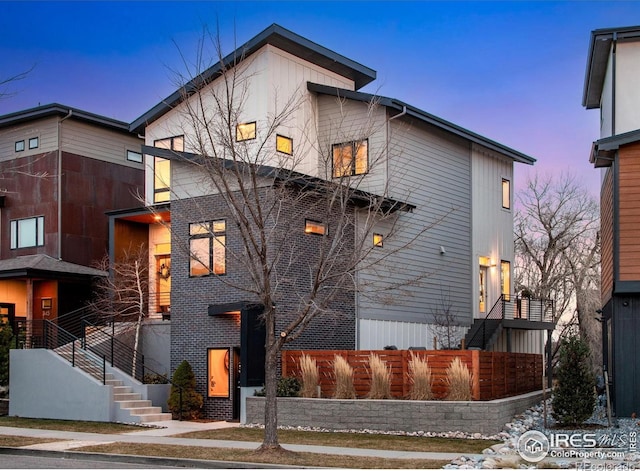 view of front of home with stairs and fence