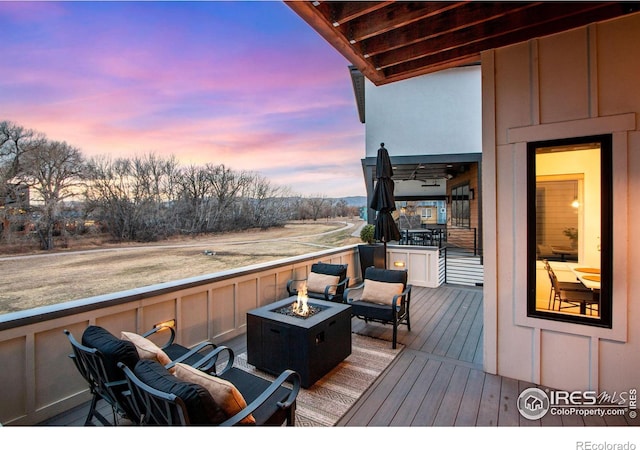 wooden deck featuring a fire pit