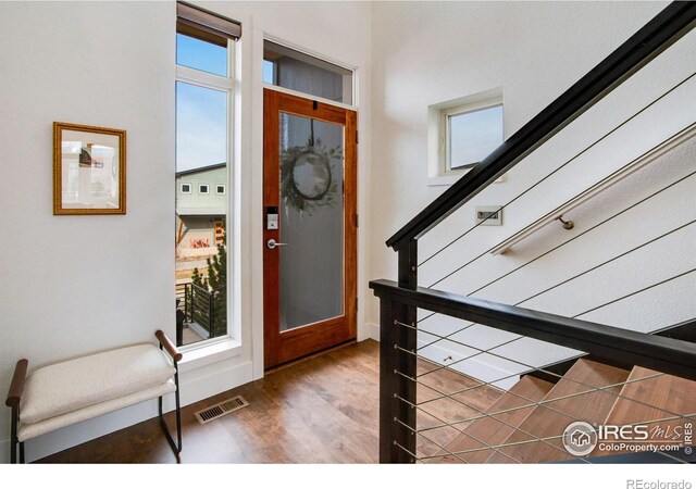 foyer with visible vents and wood finished floors