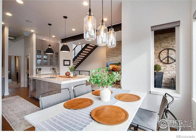 dining area with recessed lighting, stairway, and wood finished floors