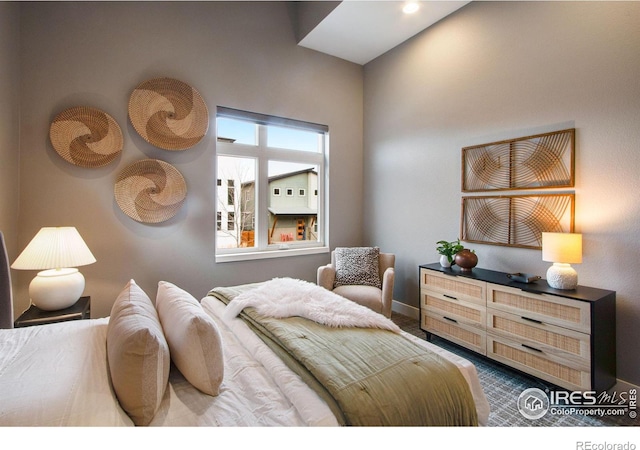 bedroom featuring baseboards and dark colored carpet