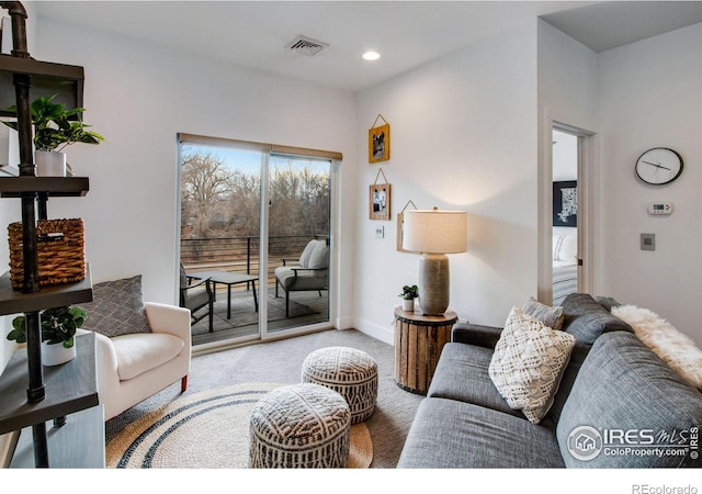 carpeted living room with visible vents, recessed lighting, and baseboards