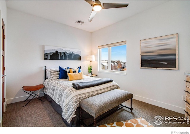 carpeted bedroom with visible vents, a ceiling fan, and baseboards