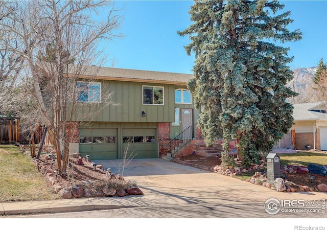 view of front of property featuring a garage, brick siding, board and batten siding, and concrete driveway