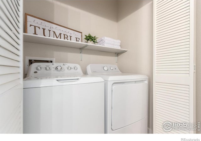 clothes washing area with separate washer and dryer and laundry area