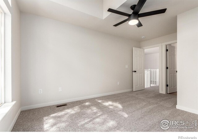 unfurnished bedroom featuring visible vents, carpet floors, and baseboards