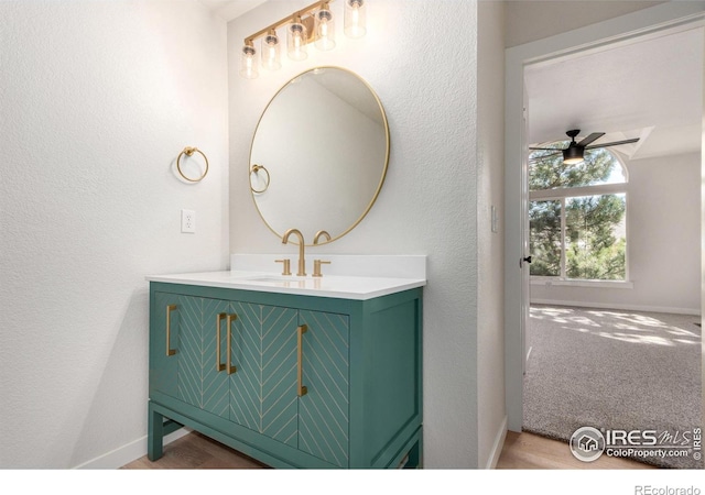 bathroom featuring baseboards, vanity, and a ceiling fan