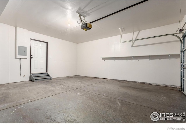 garage featuring electric panel and a garage door opener