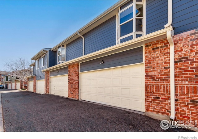 view of side of property with brick siding and a residential view