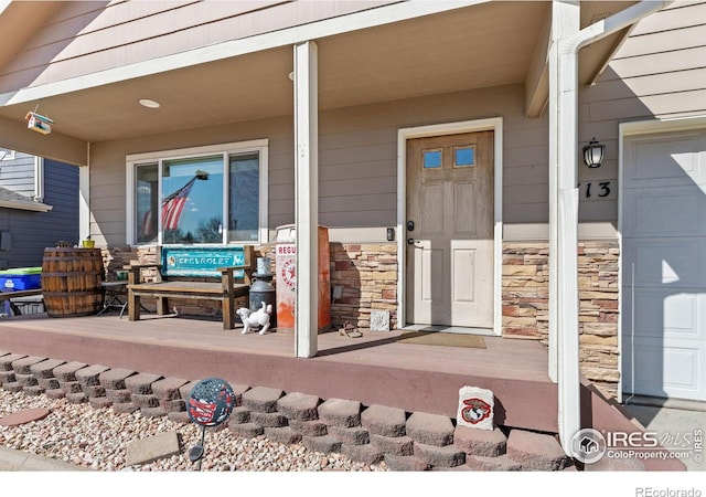 view of exterior entry featuring stone siding