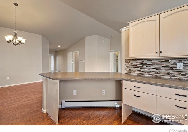 kitchen with backsplash, a peninsula, lofted ceiling, baseboard heating, and dark wood-style flooring