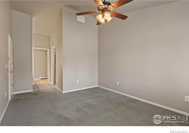 empty room featuring baseboards, a baseboard heating unit, carpet, and a ceiling fan