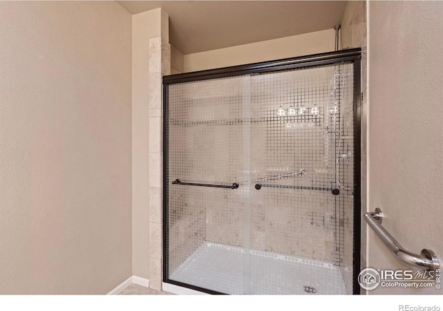 full bath featuring a shower stall