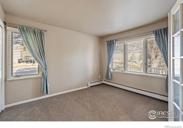 unfurnished room featuring a wealth of natural light, carpet floors, baseboards, and a baseboard radiator