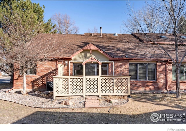 back of house featuring brick siding