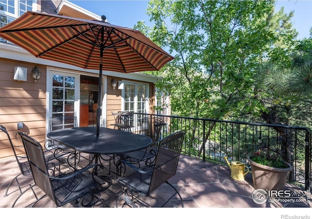 wooden terrace featuring outdoor dining area