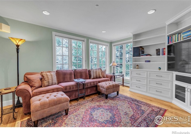 living area with crown molding, recessed lighting, plenty of natural light, and light wood-type flooring