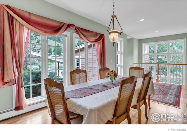 dining area featuring recessed lighting, baseboard heating, and light wood-type flooring