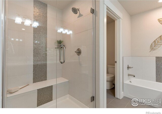 bathroom with tile patterned flooring, a shower stall, toilet, and a bathtub