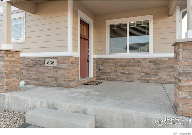 property entrance with stone siding