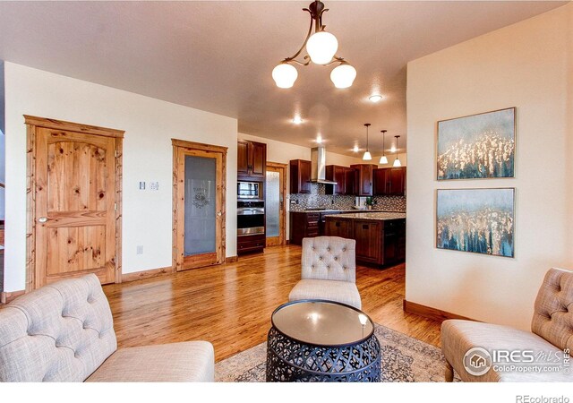 living area with light wood-style floors and baseboards