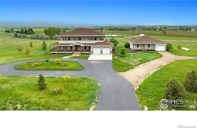 view of front facade featuring a garage, covered porch, and driveway