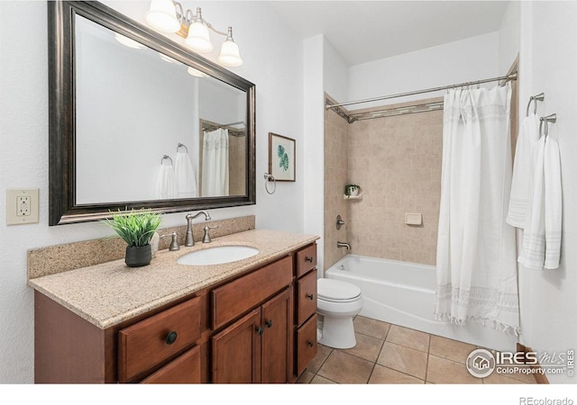 full bath with tile patterned flooring, toilet, vanity, and shower / tub combo