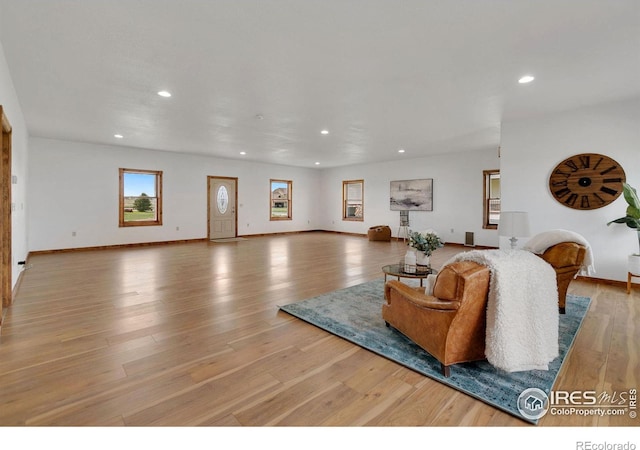 living area with recessed lighting, baseboards, and wood finished floors