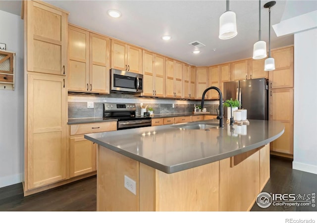 kitchen with visible vents, light brown cabinets, stainless steel appliances, and a sink