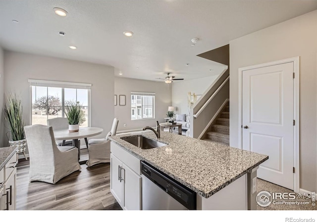 143 Robin Rd, Johnstown, CO 80534 - kitchen featuring light stone countertops, recessed lighting, a sink, white cabinets, and stainless steel dishwasher