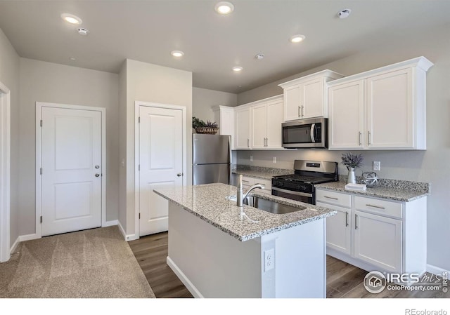 143 Robin Rd, Johnstown, CO 80534 - kitchen with an island with sink, recessed lighting, a sink, stainless steel appliances, and white cabinetry
