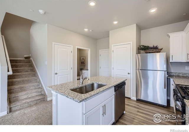 143 Robin Rd, Johnstown, CO 80534 - kitchen with a sink, recessed lighting, appliances with stainless steel finishes, white cabinets, and light stone countertops