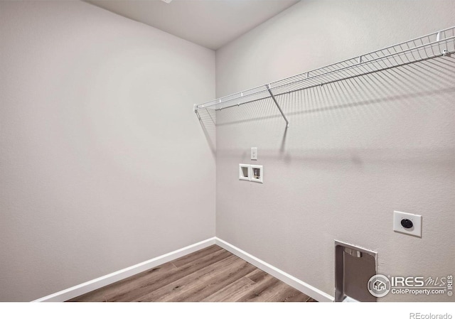 143 Robin Rd, Johnstown, CO 80534 - clothes washing area featuring baseboards, laundry area, hookup for a washing machine, wood finished floors, and electric dryer hookup