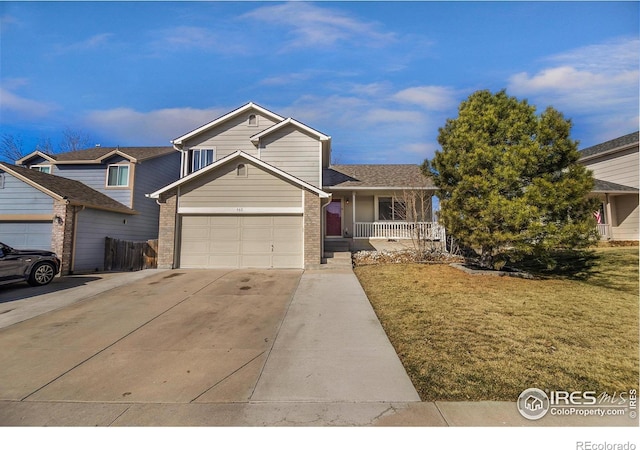 tri-level home featuring covered porch, concrete driveway, a front yard, a garage, and brick siding