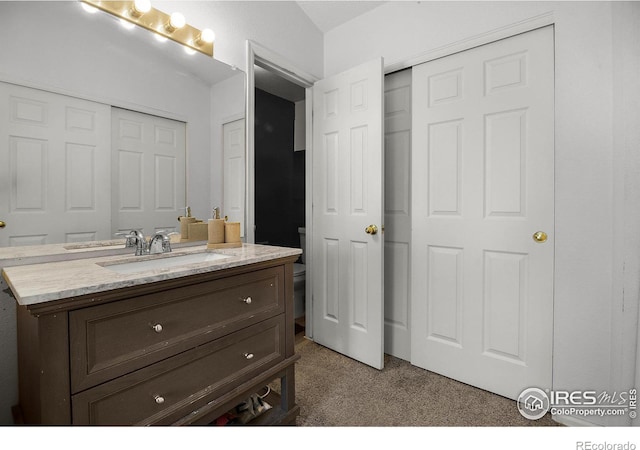 bathroom with toilet and vanity