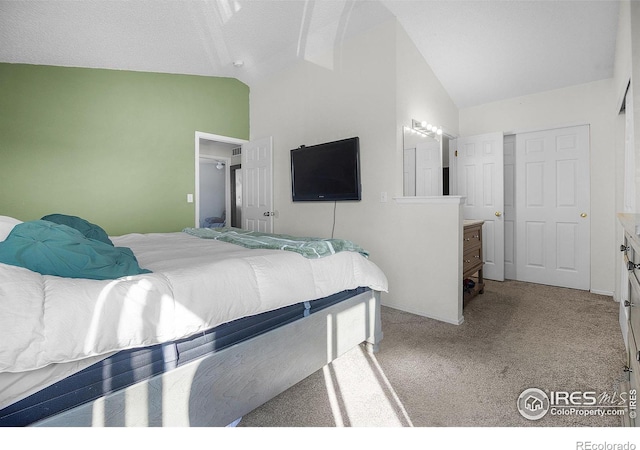 carpeted bedroom with vaulted ceiling