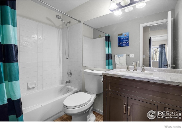 full bathroom featuring vanity, toilet, wood finished floors, and shower / tub combo