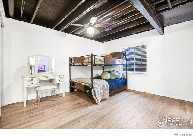 bedroom with ceiling fan, baseboards, and wood finished floors