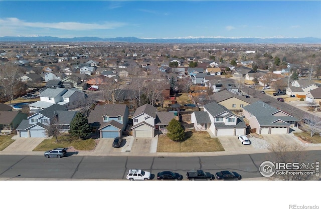 drone / aerial view with a residential view and a mountain view