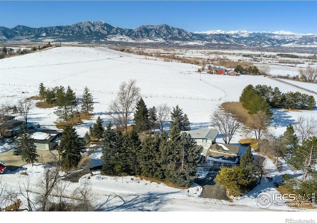 snowy aerial view featuring a mountain view