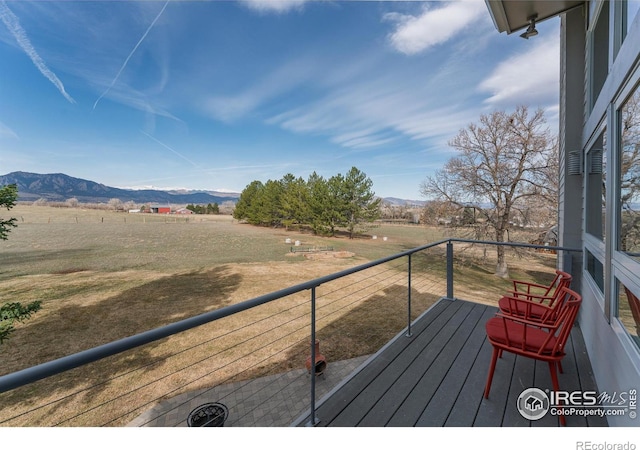 deck featuring a mountain view and a rural view