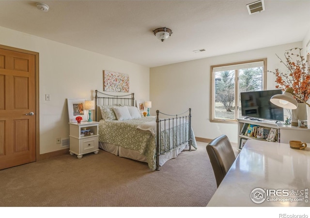 carpeted bedroom featuring visible vents and baseboards