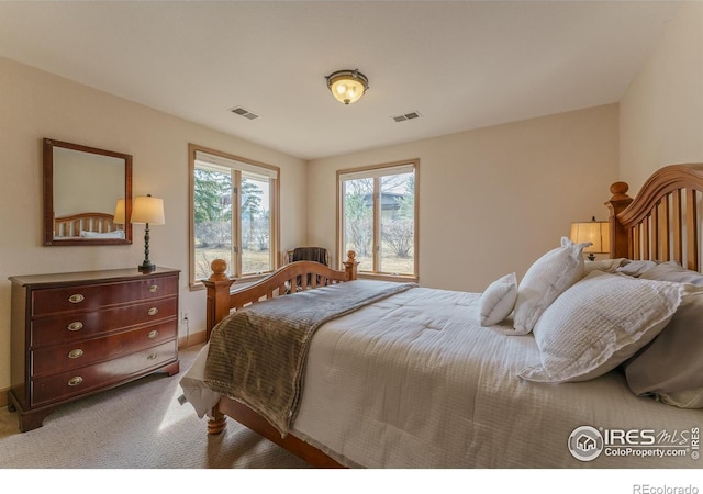 bedroom featuring visible vents, baseboards, and carpet floors